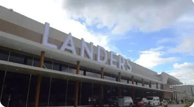 a large building with a sign on top of it at Joms Minimalist Crib Nuvali in Calamba
