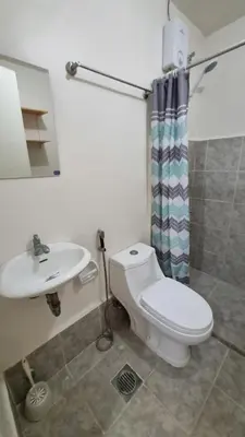 a bathroom with a toilet and a sink at Joms Minimalist Crib Nuvali in Calamba