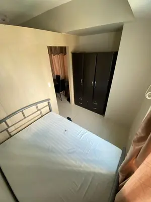 a bedroom with a large bed in a room at jazz residence in Manila