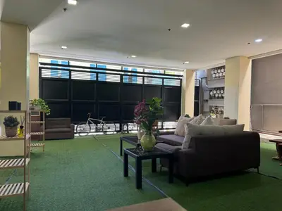 a living room with a couch and a table at Casa Maria by Juemarst Suites in Manila