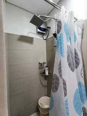 a bathroom with a shower curtain and a toilet at Shore 2 Residences in Manila
