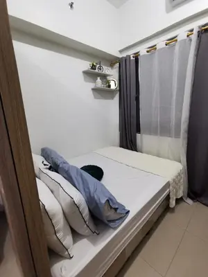 a bed in a room with pillows at Shore 2 Residences in Manila