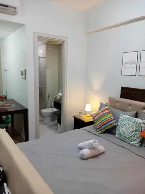 a bedroom with a bed with two towels on it at Happy stay Condotel near NAIA terminal 3 in Manila