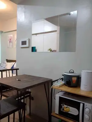 a small kitchen with a table and a microwave at Happy stay Condotel near NAIA terminal 3 in Manila