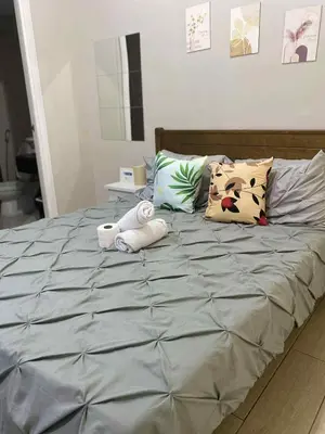 a bed with two stuffed animals on top of it at Happy stay Condotel near NAIA terminal 3 in Manila