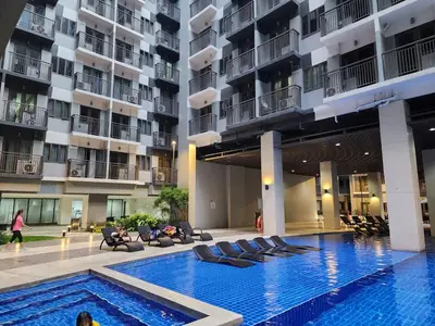 a swimming pool in the middle of a building at 1BR with balcony Condotel in MOA Complex, Entertainment City, near NAIA, free wifi, netflix in Manila