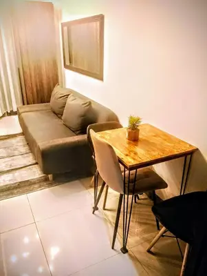 a living room with a couch and a table at 1BR with balcony Condotel in MOA Complex, Entertainment City, near NAIA, free wifi, netflix in Manila