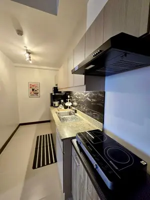 a kitchen with a stove and a sink at SG Urban Staycation in Manila