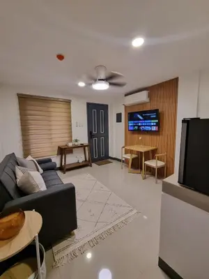 a living room with a couch and a tv at Flat 35, Unit 3C in Manila