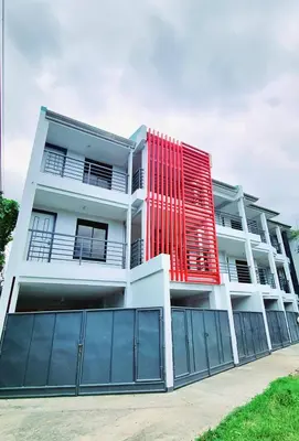 a red building on the side of a building at Flat 35, Unit 3C in Manila