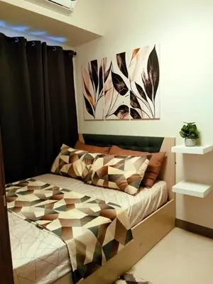 a bedroom with a bed with a geometric comforter at El Marhabea Crib in Manila