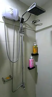 a shower in a bathroom with a blow dryer at El Marhabea Crib in Manila