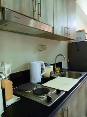 a kitchen counter with a sink and a mixer at El Marhabea Crib in Manila