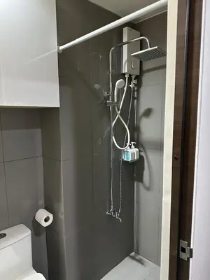 a shower in a bathroom with a toilet at 1BR Air Residences condo, Ayala Ave, Makati in Manila