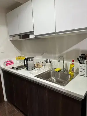 a kitchen with a sink and a counter top at 1BR Air Residences condo, Ayala Ave, Makati in Manila