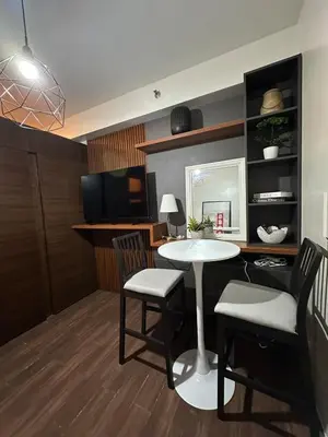 a dining room with a table and two chairs at 1BR Air Residences condo, Ayala Ave, Makati in Manila