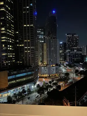 a view of a city at night with tall buildings at 1BR Ayala Makati Apartment at Lush Residences in Manila