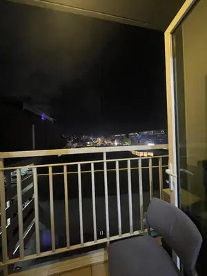 a balcony with a view of the city at night at 10hrs stay in Manila