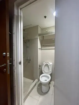 a bathroom with a white toilet and a shower at 10hrs stay in Manila