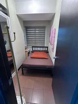 a small bedroom with a bed in a room at Phebestaycation in Manila