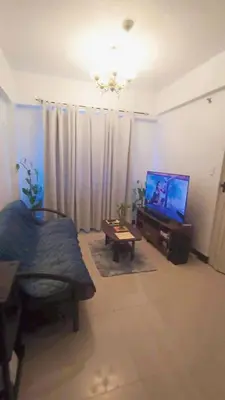 a living room with a flat screen tv and a couch at Casa Broganza in Manila