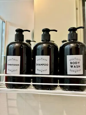 four bottles of soap on a shelf in a store at Casa Valentine - Azure Urban Resorts Residences in Manila