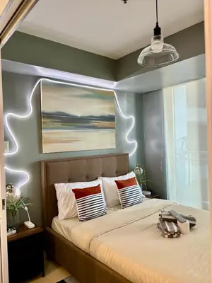 a bedroom with a bed with a painting above it at Casa Valentine - Azure Urban Resorts Residences in Manila