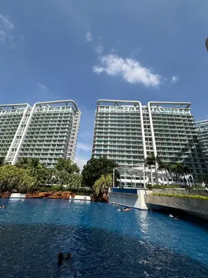 two large buildings in the middle of a river at Casa Valentine - Azure Urban Resorts Residences in Manila