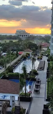 a view of a resort with a pool and tables at Coast Residences Pasay City 1 bedroom in Manila