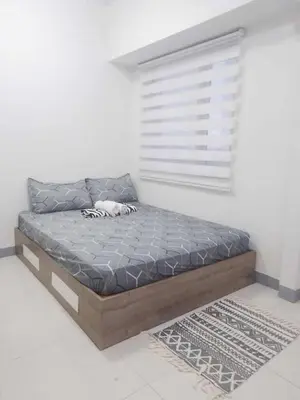 a bed sitting in a room with a window at Coast Residences Pasay City 1 bedroom in Manila