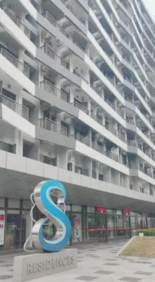 a large building with a s sign in front of it at Mall of Asia Condo Pasay in Manila