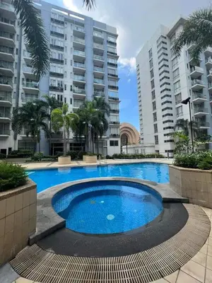 a large swimming pool in front of some buildings at One Palm Tree Villas Near NAIA terminal 3 in Manila
