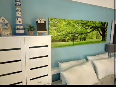 a bedroom with a white dresser and a painting on the wall at One Palm Tree Villas Near NAIA terminal 3 in Manila