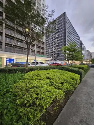 a green hedge in front of a building at Adventura Staycation in Manila