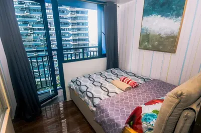 a bedroom with a bed and a large window at Air residence Snuggle in Style 1 BR condo Makati swim gym park surf 300 Mb in Manila