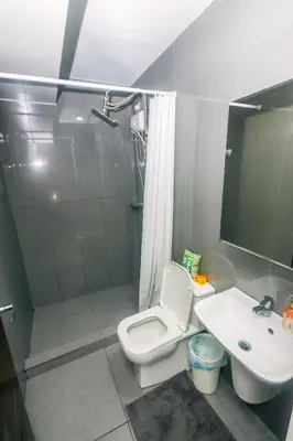 a bathroom with a toilet and a sink at Urban Oasis Sleep in Style Makati Comfy Gym Swim Park 914 in Manila