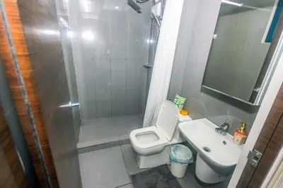 a bathroom with a shower and a toilet and a sink at Urban Oasis Sleep in Style Makati Comfy Gym Swim Park 914 in Manila