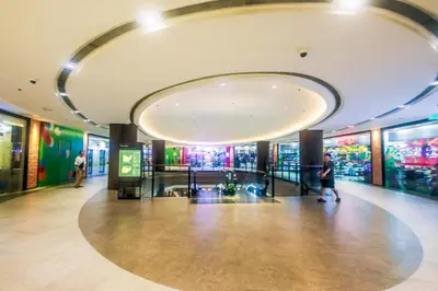 a lobby of a building with people walking in it at Urban Oasis Sleep in Style Makati Comfy Gym Swim Park 914 in Manila