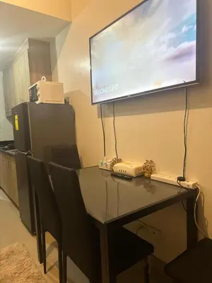 a room with a table with chairs and a projection screen at Jaja staycation in Manila