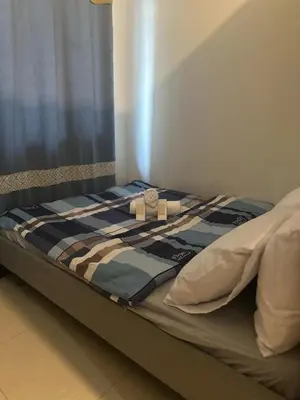 a bed with a box on top of it at Jaja staycation in Manila