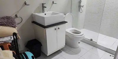a bathroom with a sink and a toilet and a shower at Short Stay BF Resort in Manila