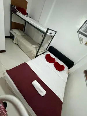 a bed with red roses on it in a room at 143 Private Resort in Trece Martires