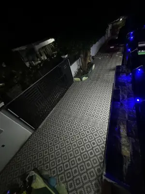 a bench on a sidewalk at night with lights at 143 Private Resort in Trece Martires