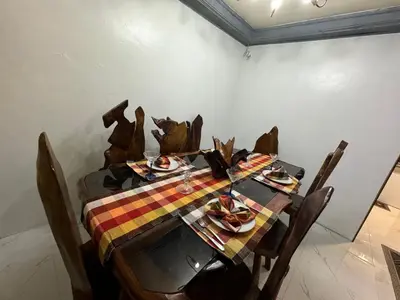 a dining room table with a table cloth on it at 143 Private Resort in Trece Martires