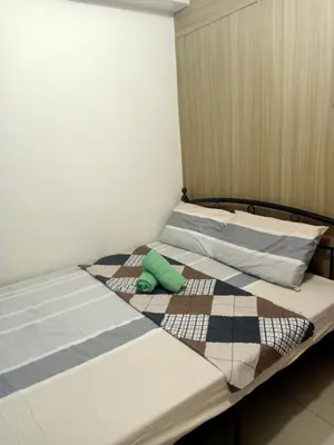 a bedroom with two twin beds with pillows at Staycation in Shore Residence's in Manila