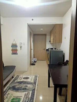 a room with a kitchen with a rug on the floor at Staycation in Shore Residence's in Manila