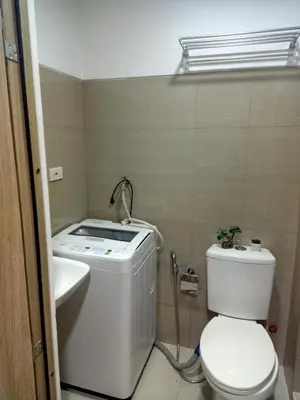 a small bathroom with a toilet and a sink at Staycation in Shore Residence's in Manila