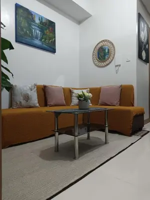 a living room with a couch and a table at SMDC Red residences Condominium Makati City in Manila
