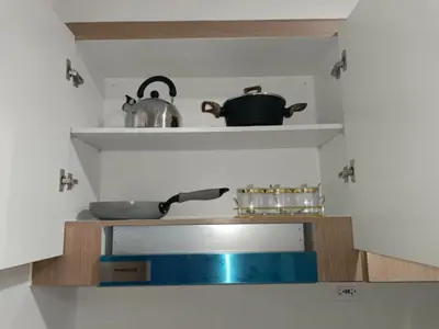 a kitchen with a sink and a pot on a shelf at SMDC Red residences Condominium Makati City in Manila
