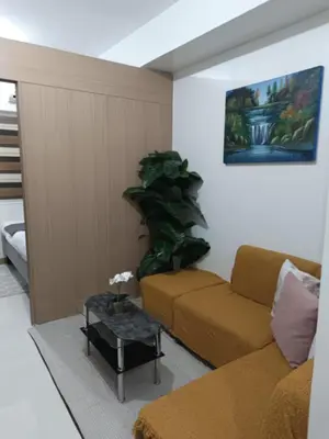 a living room with a couch and a table at SMDC Red residences Condominium Makati City in Manila